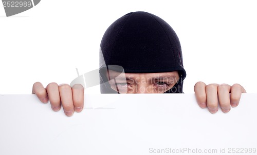 Image of Robber hiding behind a empty white  space for text