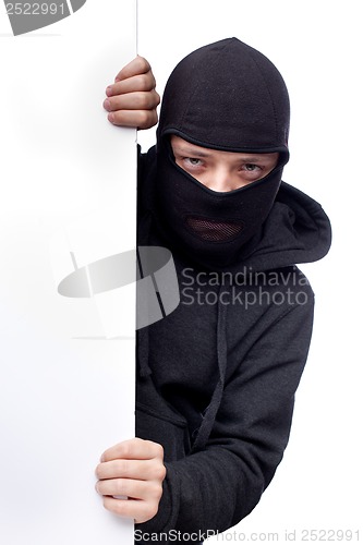 Image of Robber hiding behind a empty white  space for text