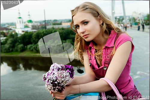 Image of Pretty woman holding a bouquet
