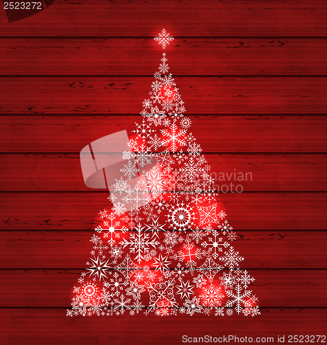 Image of Christmas fir made of snowflakes on wooden background