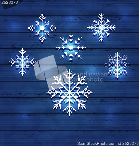 Image of Christmas set variation snowflakes on wooden background