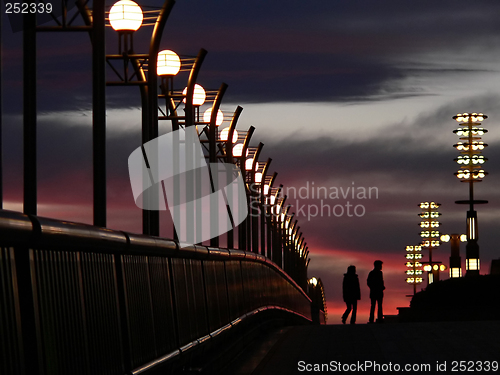 Image of walking couple and evening sky