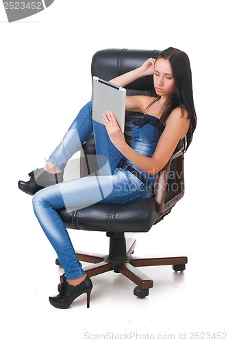 Image of Woman using a touch-pad PC sitting in chair