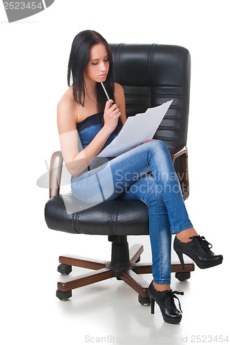 Image of Young girl with sheets of paper and pencil.