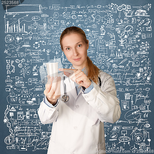 Image of Doctor woman with cup for analysis