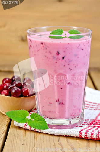 Image of Milk cocktail with cranberries on the board