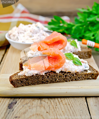 Image of Sandwiches on bread with salmon on board