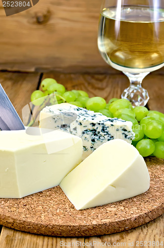 Image of Cheese with wine and grapes on the board