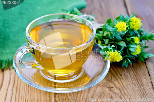 Image of Herbal tea with a bouquet of Rhodiola rosea on the board