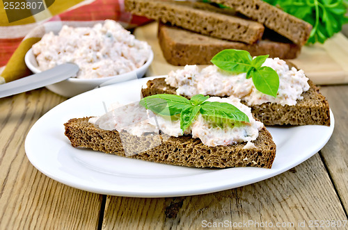 Image of Sandwiches with cream of salmon and mayonnaise on the board