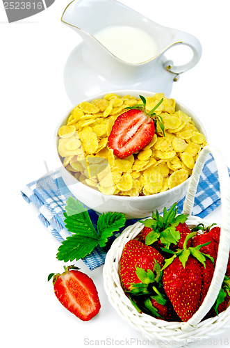 Image of Cornflakes with milk in a jug and strawberries