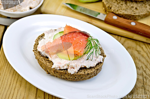 Image of Sandwich with cream and salmon on an oval plate