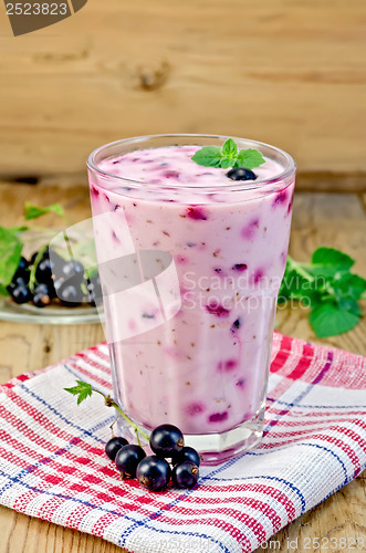 Image of Milk cocktail with black currants on the board