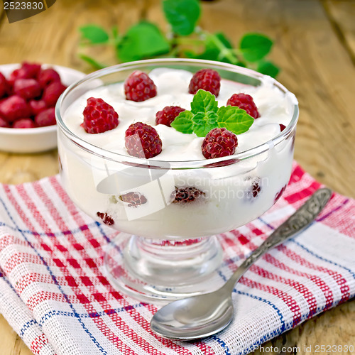 Image of Yogurt thick with raspberries and mint on the board