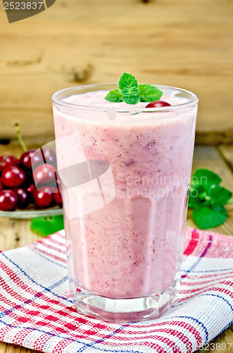 Image of Milk cocktail with cherry on the board
