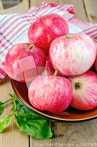 Image of Apples red in a ceramic bowl on a board