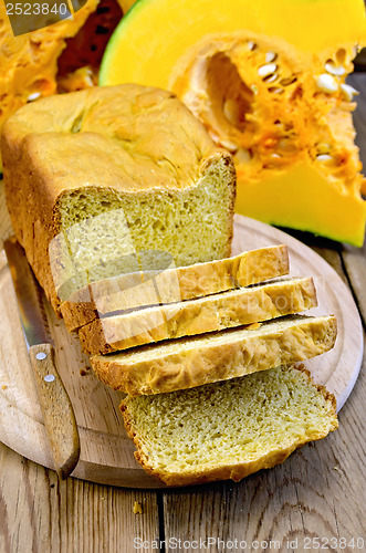 Image of Bread homemade pumpkin on a board with a knife