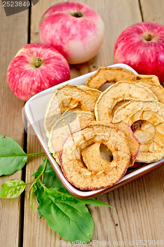 Image of Apples fresh and dried red in a bowl on the board