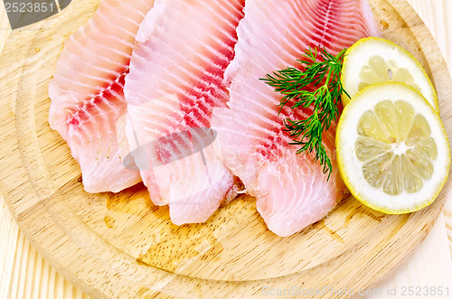 Image of Fillets tilapia on a round board