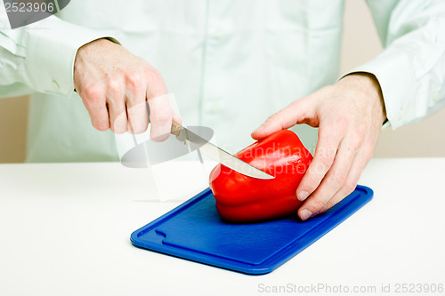 Image of Man's hand cut red pepper