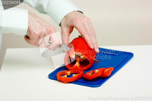 Image of Man's hand cut red pepper