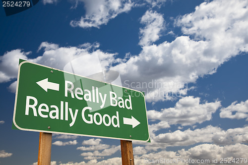 Image of Really Bad, Really Good Green Road Sign and Clouds