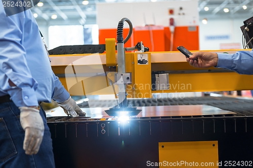 Image of Machine cutting steel in a factory