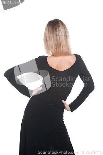 Image of Trendy blonde woman in black dress standing back