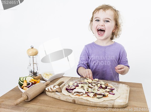 Image of happy child making pizza