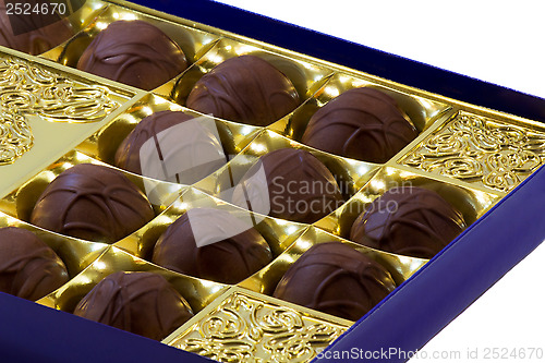 Image of Chocolate sweets in the box on the white background.