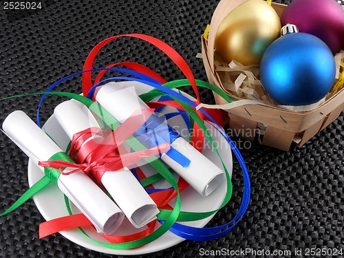 Image of white invitation paper with gift and christmas balls