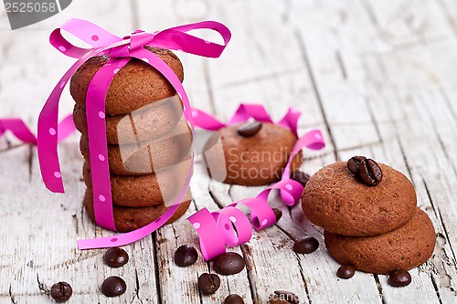 Image of stack of chocolate cookies tied with pink ribbon and coffee bean