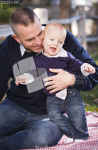 Image of Infant Boy and Young Military Father Play in the Park