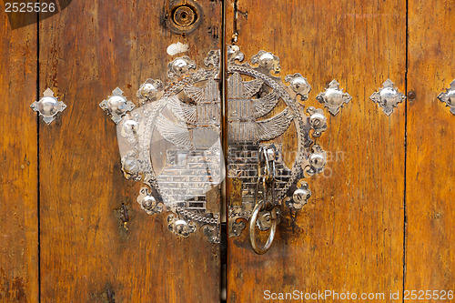 Image of Metallic door knob with wooden door