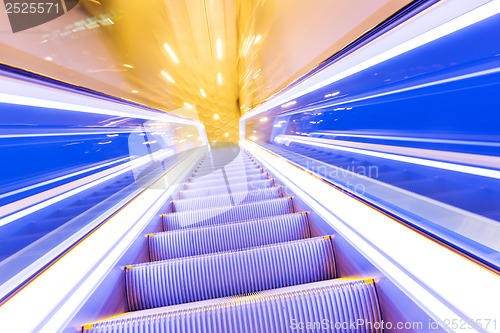 Image of Movement of diminishing hallway escalator