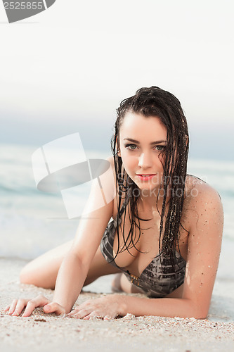 Image of Woman lying near the sea