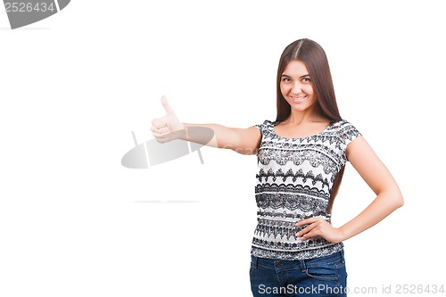 Image of Attractive young woman shows thumb up sign