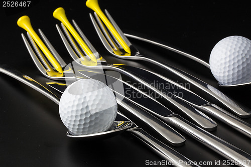 Image of Forks,spoons and knifes and golf balls