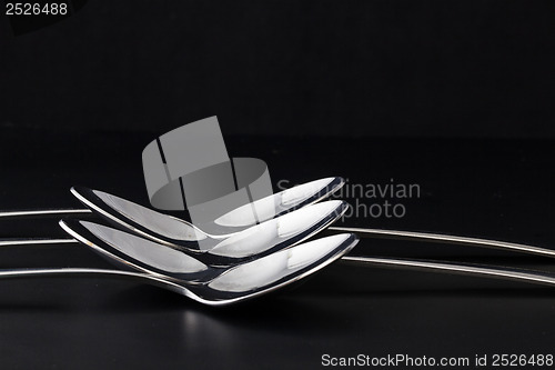 Image of Spoons on a black table