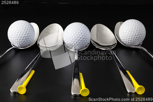 Image of Spoons and golf balls 