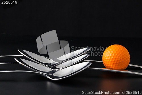 Image of Spoons and golf balls 