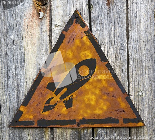 Image of Icon of Go Up Rocket on Rusty Warning Sign.