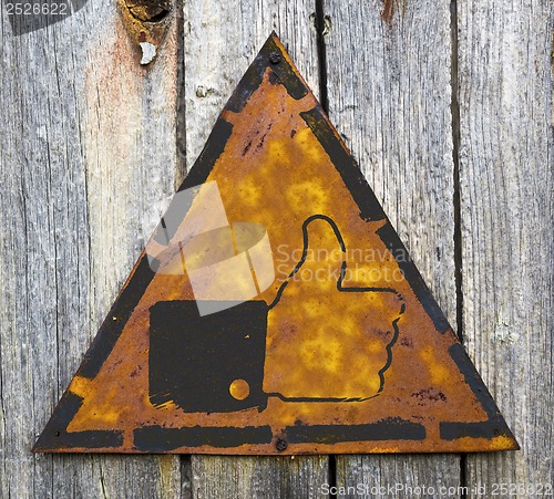 Image of Thumb Up Icon on Rusty Warning Sign.