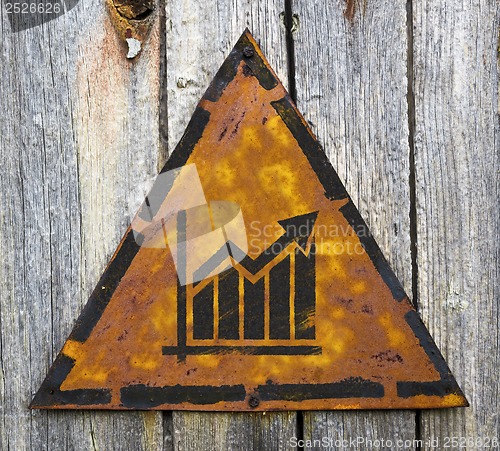 Image of Growth Chart Icon on Rusty Warning Sign.