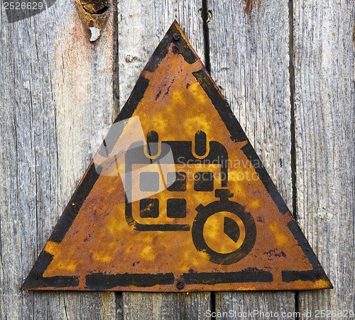 Image of Calendar with Stopwatch on Rusty Warning Sign.