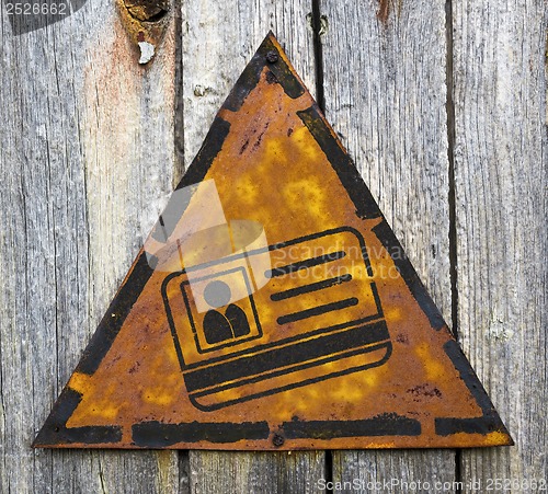 Image of ID Card Icon on Rusty Warning Sign.