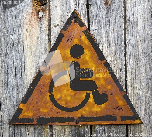Image of Disabled Icon on Rusty Warning Sign.