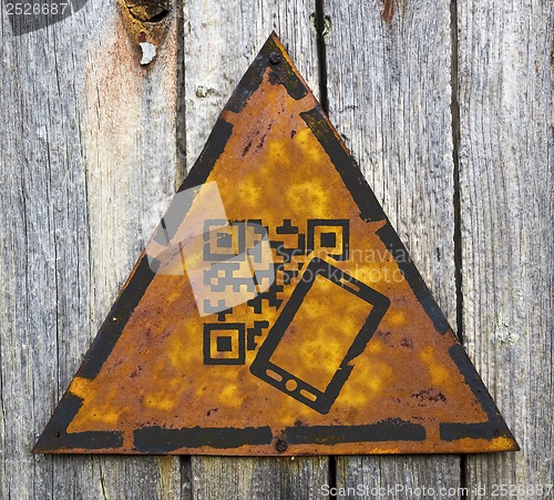 Image of QR Code Icon on Weathered Warning Sign.