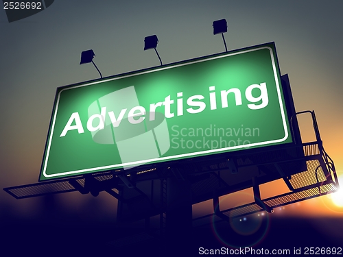 Image of Advertising on Green Billboard at Sunrise.