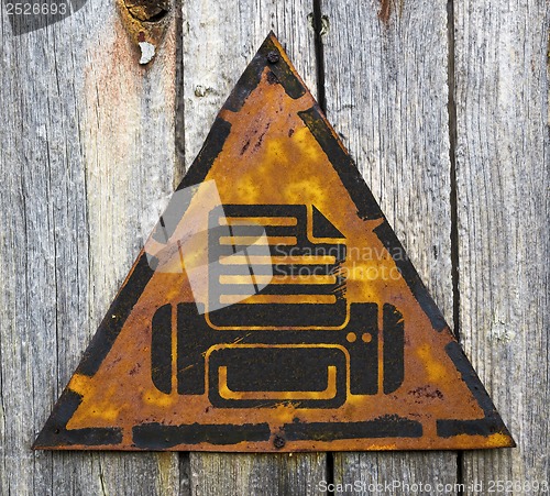 Image of Printer Icon on Weathered Warning Sign.